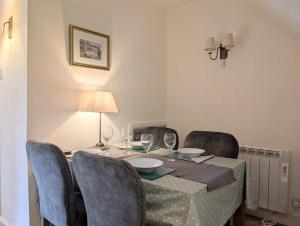 a dining room table with chairs and a table with wine glasses at 2 Bed in Elterwater oc-gl053 in Chapel Stile +5 photos