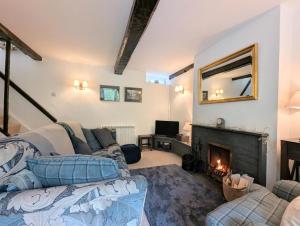 a living room with a couch and a fireplace at 2 Bed in Elterwater oc-gl053 in Chapel Stile