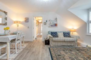 a living room with a couch and a table at 2 Bed in Swanage oc-wy527 in Swanage