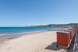 a beach with a row of containers on it at 2 Bed in Swanage oc-wy527 in Swanage +13 photos