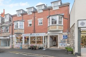 a brick building with a flower shop on the street at 2 Bed in Swanage oc-wy527 in Swanage
