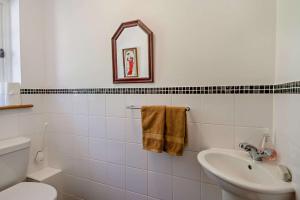 a bathroom with a sink and a toilet and a mirror at 2 Bed in Lindsey oc-w28111 in Monks Eleigh +6 photos