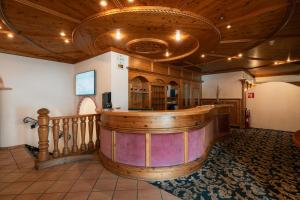 a bar in a room with a wooden ceiling at Sporthotel Kurzras in Maso Corto