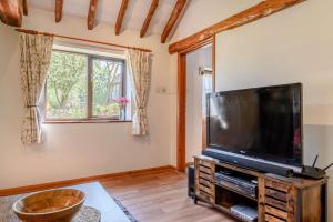 a living room with a large flat screen tv at 1 Bed in Saxmundham oc-c27420 in Farnham