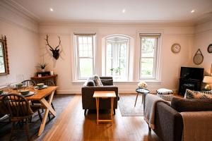 a living room with a couch and a table at Enbrook View in Sandgate