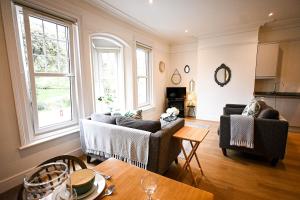 a living room with two couches and a table at Enbrook View in Sandgate