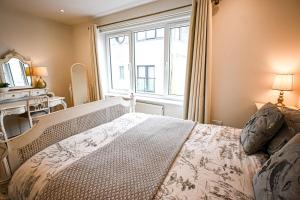 a bedroom with a large window and a large bed at Enbrook View in Sandgate