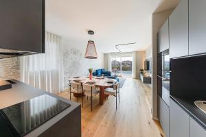 a kitchen and living room with a table and a dining room at Luxury Villa Prestige in Sirmione