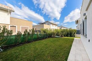 a backyard of a house with a green yard at Luxury Villa Prestige in Sirmione