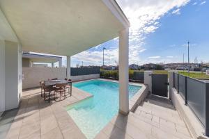 a swimming pool on a balcony with a table and chairs at Luxury Villa Prestige in Sirmione