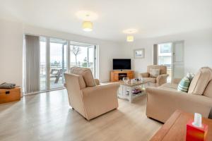 a living room with a couch and chairs and a television at 2 Bed in Bournemouth oc-b27914 in Bournemouth