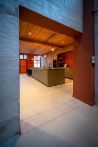 an open kitchen and dining room in a building at In De Rooden Hoed in Poperinge