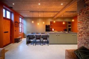 a large kitchen with a table and chairs at In De Rooden Hoed in Poperinge