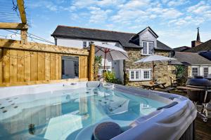 a swimming pool in front of a house at 9 Bed in St. Agnes oc-port20 in St. Agnes