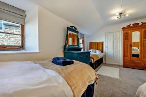 a bedroom with two beds and a blue dresser at 9 Bed in St. Agnes oc-port20 in St. Agnes +25 photos