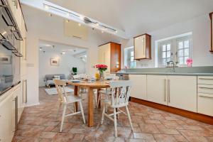 a kitchen with a table and chairs in a kitchen at 9 Bed in St. Agnes oc-port20 in St. Agnes