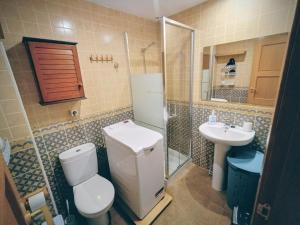 a bathroom with a toilet and a sink at Sierra y Silencio Nómada, WIFI, Trastero y Garaje in Güéjar-Sierra