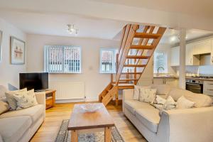 a living room with a staircase and a couch at 2 Bed in Bodham oc-m15008 in Bodham