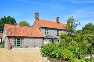 an old stone house with a red roof at 2 Bed in Bodham oc-m15008 in Bodham