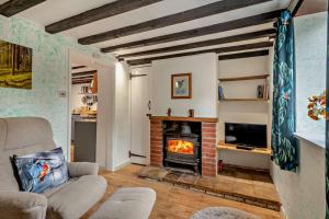 a living room with a fireplace and a couch at 2 Bed in Bodham oc-t27775 in Bodham