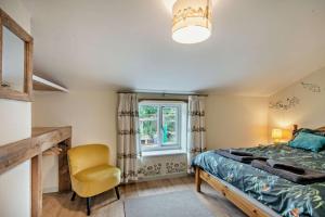 a bedroom with a bed and a chair and a window at 2 Bed in Bodham oc-t27775 in Bodham