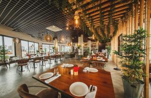a restaurant with a large wooden table and chairs at Pool View Apartment with Hotel Facilities in Iskele