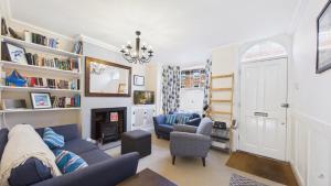 a living room with two blue couches and a fireplace at 74 Granville Road in Cowes
