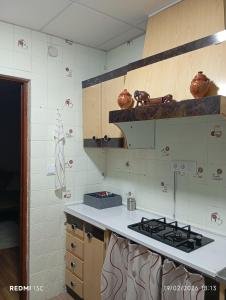 a kitchen with a stove and a counter top at La casita in Medellín