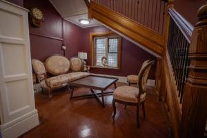 a living room with a staircase and a table and chairs at Willingham House Hotel in Willingham