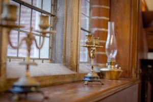 two candlesticks sitting on a window sill next to acandle at Willingham House Hotel in Willingham