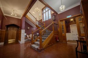 a hallway with a spiral staircase in a house at Willingham House Hotel in Willingham