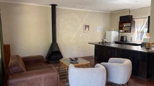 a kitchen with a living room with a stove at The Stix in Dullstroom