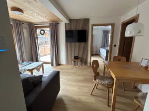 a living room with a couch and a dining room at Landhaus Sonnenwang in Pfronten
