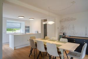 a kitchen and dining room with a table and chairs at Chambres d'hôtes Les Vergers in Chalais +6 photos