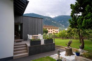 a patio with a table and chairs and mountains at Chambres d'hôtes Les Vergers in Chalais