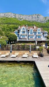 a villa with a swimming pool and a house at Hôtel La Maison Bleue par Yoann CONTE in Veyrier-du-Lac