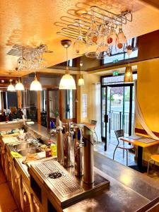 a kitchen with a sink and a counter top at Hotel de la gare des Ecrins in LʼArgentière-la-Bessée