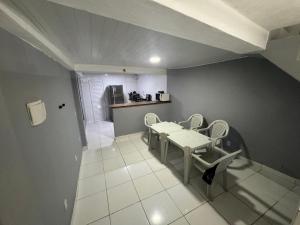 a room with a table and chairs and a kitchen at THE BROTHERS in Angra dos Reis