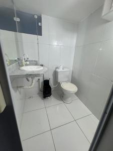 a white bathroom with a toilet and a sink at THE BROTHERS in Angra dos Reis +5 photos