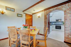 a kitchen and dining room with a table and chairs at 2 Bed in St. Merryn oc-w29716 in Saint Merryn +15 photos