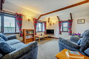 a living room with two couches and a tv at 2 Bed in St. Merryn oc-w29716 in Saint Merryn