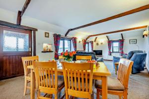 a dining room and living room with a table and chairs at 2 Bed in St. Merryn oc-w29716 in Saint Merryn