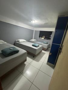 a small bedroom with two beds and a tv at THE BROTHERS in Angra dos Reis