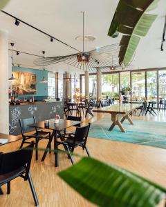 a restaurant with tables and chairs and windows at Lendhotel in Graz