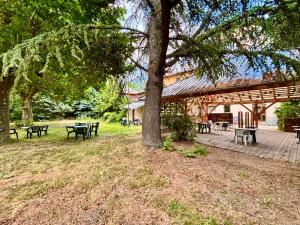 a group of tables and benches in a park at Hotel de la gare des Ecrins in LʼArgentière-la-Bessée