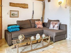 a living room with a couch and a coffee table at Apartment Les Grangettes by Interhome in Auberson +21 photos