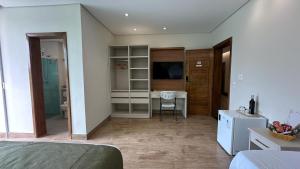 a bedroom with a bed and a desk in a room at Rincão Resort in São Paulo