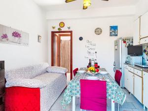 a living room with a table and a couch at Apartment Clara by Interhome in Fondachello