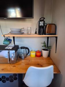 a desk with a white chair in a room at Cozy City Studio Escape in Centurion