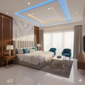 a bedroom with a large bed and two blue chairs at Hotel King Plaza in Nikurān
